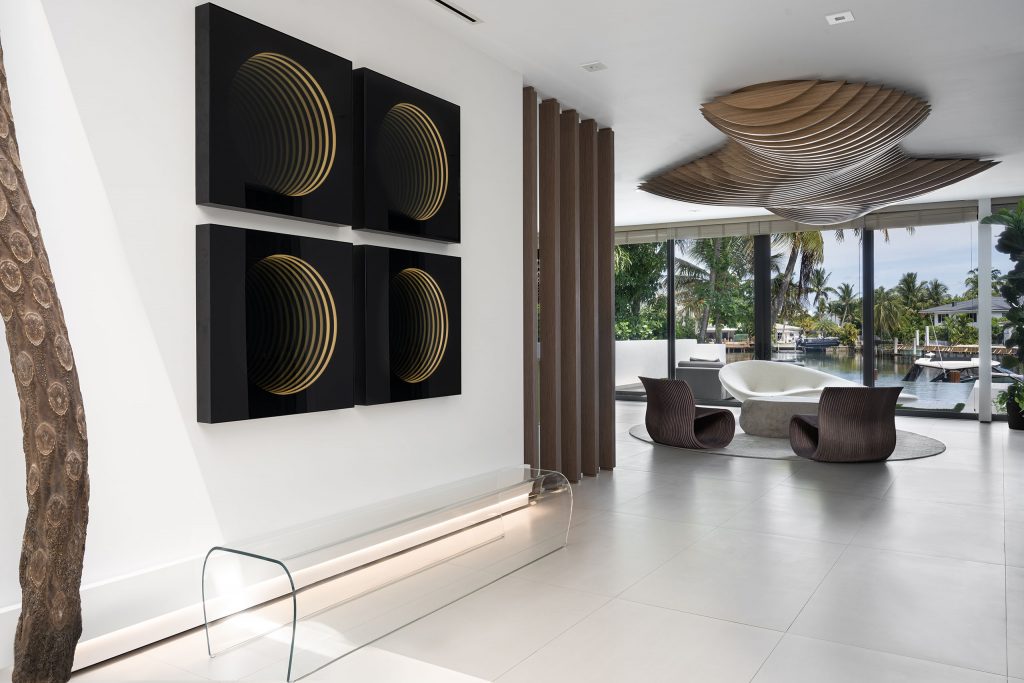 Contemporary interior design nature inspired with organic-shaped ceiling sculpture in wood, wood columns, organic shaped wood chairs and futuristic infinity mirror artworks in black and yellow