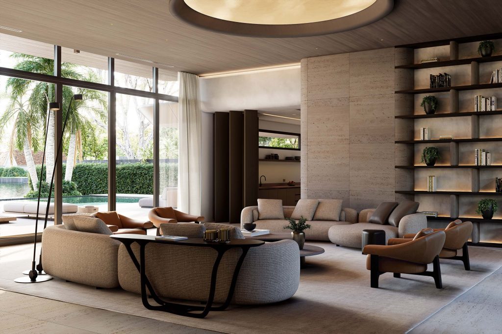 Living room with curved beige bouclé sofas and terracotta leather lounge chairs arranged around a black sculptural coffee table on a neutral rug. A circular back-illuminated ceiling panel glows within the wood-finished ceiling, while a full-height stone bookshelf with lit niches, books, and trailing plants lines the wall. Glass doors open to a garden with palms, a pool, and the kitchen visible beyond.